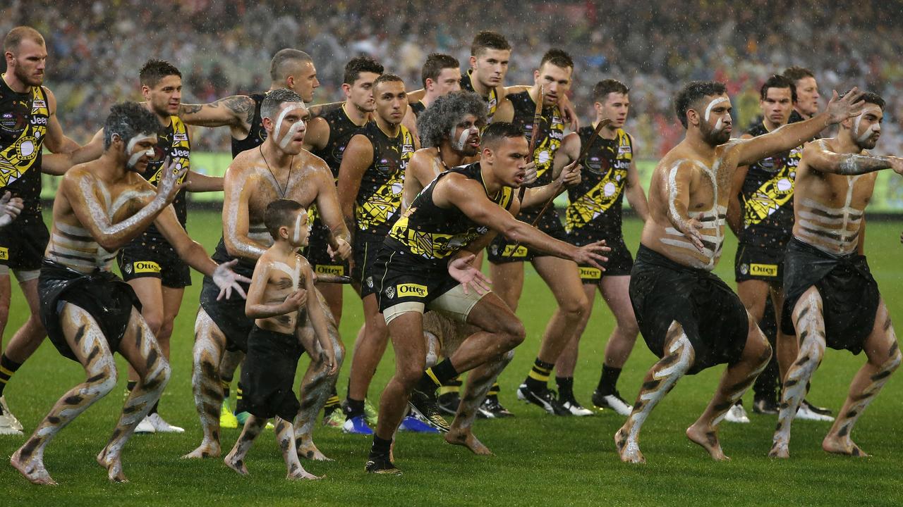 Sydney Stack of the Tigers leads a war dance before the Dreeamtime at the MCG game in 2019. (AAP Image/Mark Dadswell)