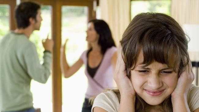 Girl covering ears while parents fight. Children. Kids. Family. Generic image.