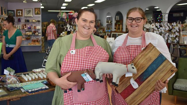 Sisters Lynette Vicary and Emily Vicary holding some of their favourite items from Burnett Christmas. ​Photo: Kristen Camp