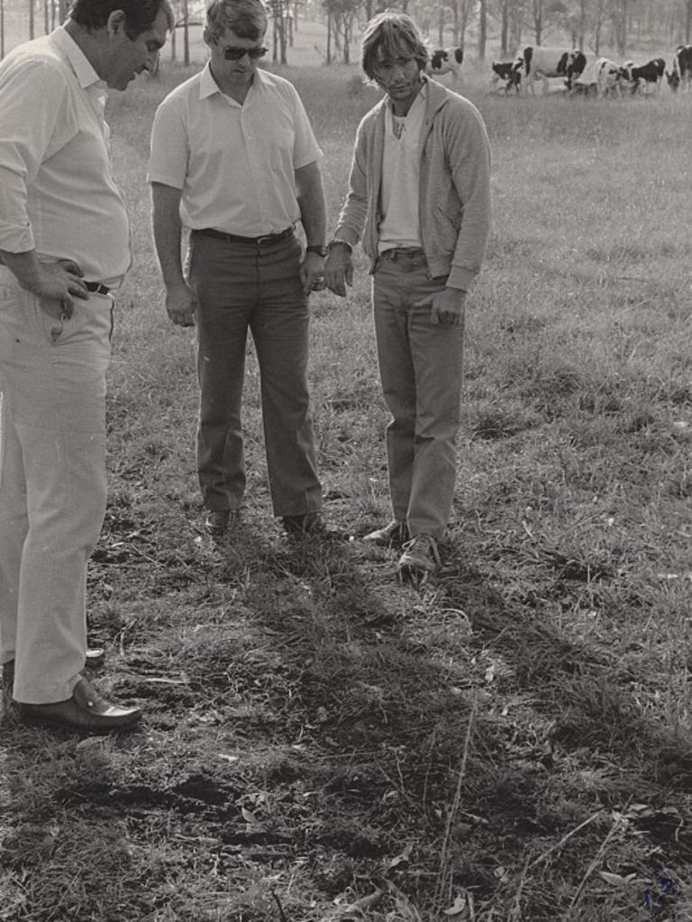 Gary Murphy, his hands un-inked, with detectives in the paddock where he killed Anita Cobby. Picture: New Holland publishing