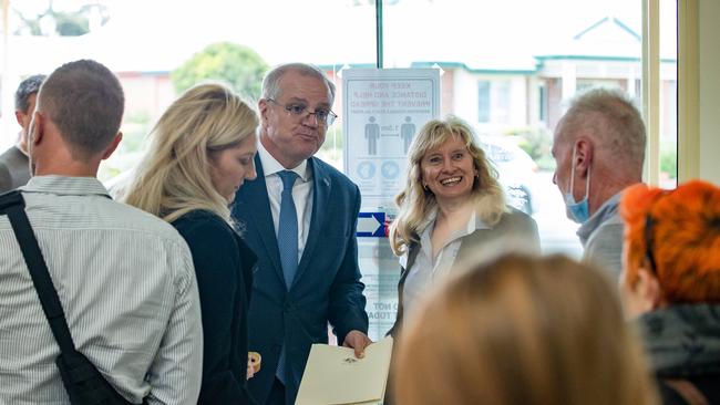 The PM eats a pastry from the village. Picture: Jason Edwards