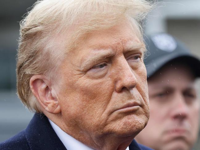 MASSAPEQUA, NEW YORK - MARCH 28: Former President Donald Trump stands silently after giving a brief statement after attending the wake for slain NYPD Officer Jonathan Diller at the Massapequa Funeral Home on March 28, 2024 in Massapequa, New York. Officer Diller was killed on March 25th when he was shot in Queens after approaching an illegally parked vehicle. Two suspects have been arrested and charged, and are being held without bail for the killing.   Michael M. Santiago/Getty Images/AFP (Photo by Michael M. Santiago / GETTY IMAGES NORTH AMERICA / Getty Images via AFP)