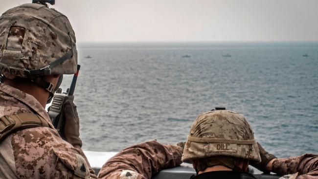 US sailors aboard an amphibious transport dock ship as they keep watch on Iranian fast inland attack crafts in the Strait of Hormuz. Picture: AFP Photo/ US Navy Office of Information