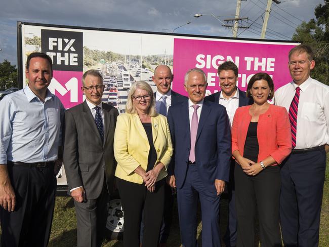 Prime Minister Malcolm Turnbull (fourth from right) with LNP members near the M1 Pacific Motorway this week. Picture: Glenn Hunt/AAP