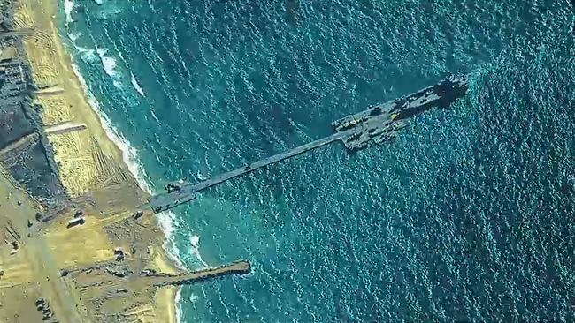 U.S. Army Soldiers assigned to the 7th Transportation Brigade (Expeditionary), U.S. Navy Sailors assigned to Amphibious Construction Battalion 1, and Israel Defense Forces emplace the Trident Pier, May 16, 2024 on the Gaza coast. Picture: Getty