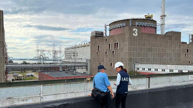 IAEA Deputy Director General, Head of Department of Nuclear Safety and Security, Lydie Evrard (R) with IAEA staff visit the roof top of the special building at the Zaporizhzhia NPP that houses, among other items, fresh nuclear fuel and solid radioactive waste storage facility. Picture; AFP.