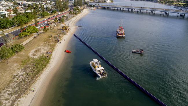 A pipeline being towed along the Broadwater and installed under the Nerang River as part of the City’s Long Term Recycled Water Release Plan. Picture: Jerad Williams