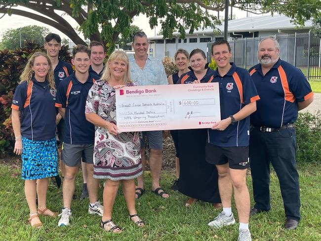 Sharyn Morcom, Sean Parnell and Umpire's Association president Mark Noonan present a cheque to the Breast Cancer Network Australia.