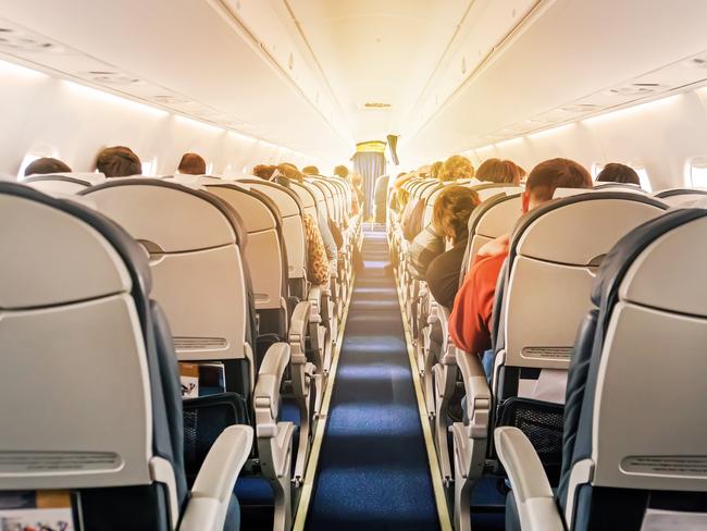 Commercial aircraft cabin with rows of seats down the aisle. morning light in the salon of the airliner. economy class. Picture: iStockglobal roaming, Dilvin yasa, Escape