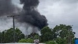 Black smoke can be seen as fire breaks out at Gold Coast holiday park. Picture: Facebook