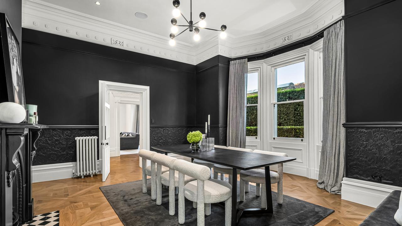 The formal dining room retains its 19th-century grandeur with restored period detailing.