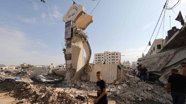 Palestinians survey the destruction following an Israeli military raid on the Jenin Palestinian refugee camp, in Jenin in the Israeli occupied northern West Bank. Picture: AFP