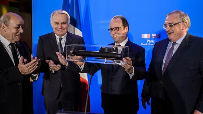 French President Francois Hollande shows off a model of a submarine that a French shipbuilder will build for Australia. Picture: Christophe Petit Tesson/Pool Photo via AP