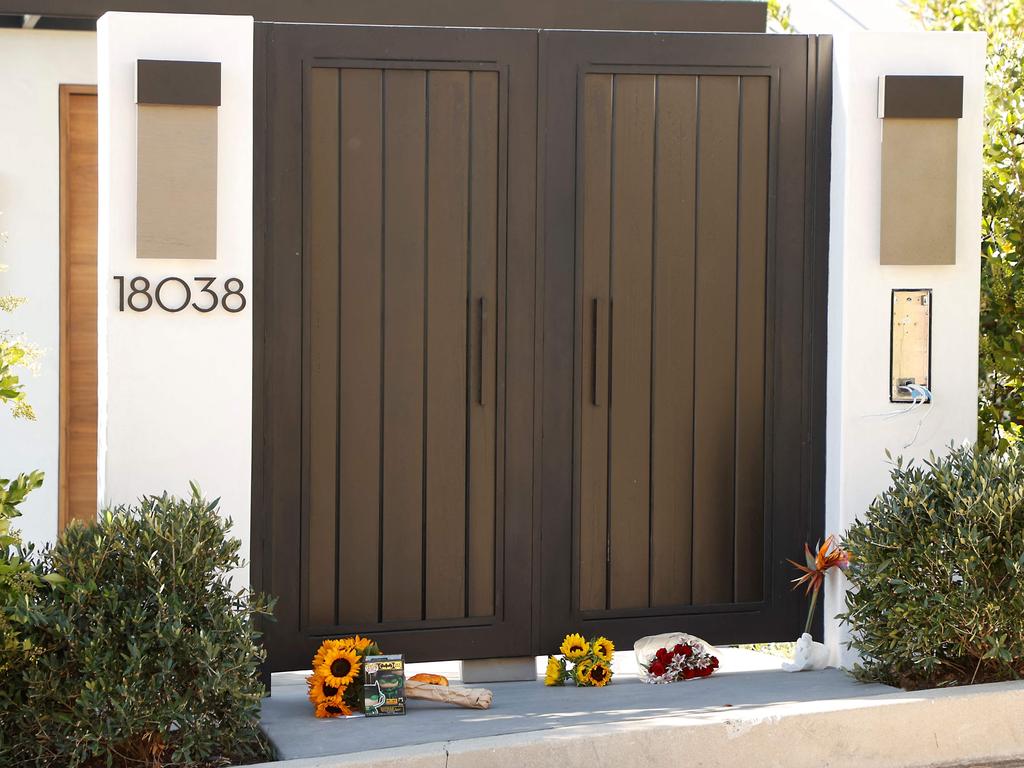 Flowers and other objects are seen outside Perry’s Pacific Palisades home in LA. Picture: Michael Tran/AFP