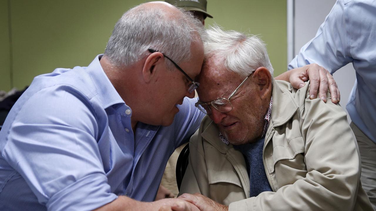 Prime Minister Scott Morrison comforts Owen Whalan on Sunday. Picture: AAP