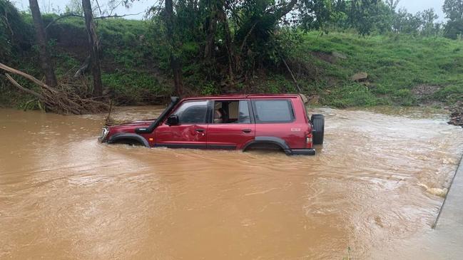 A man's 4WD remains in Eel Creek after it was swept away at least 200m downstream.