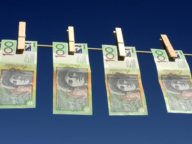 Four Australian $100.00 notes hanging on the line; Australian dollars on clothes line with peg, generic cash