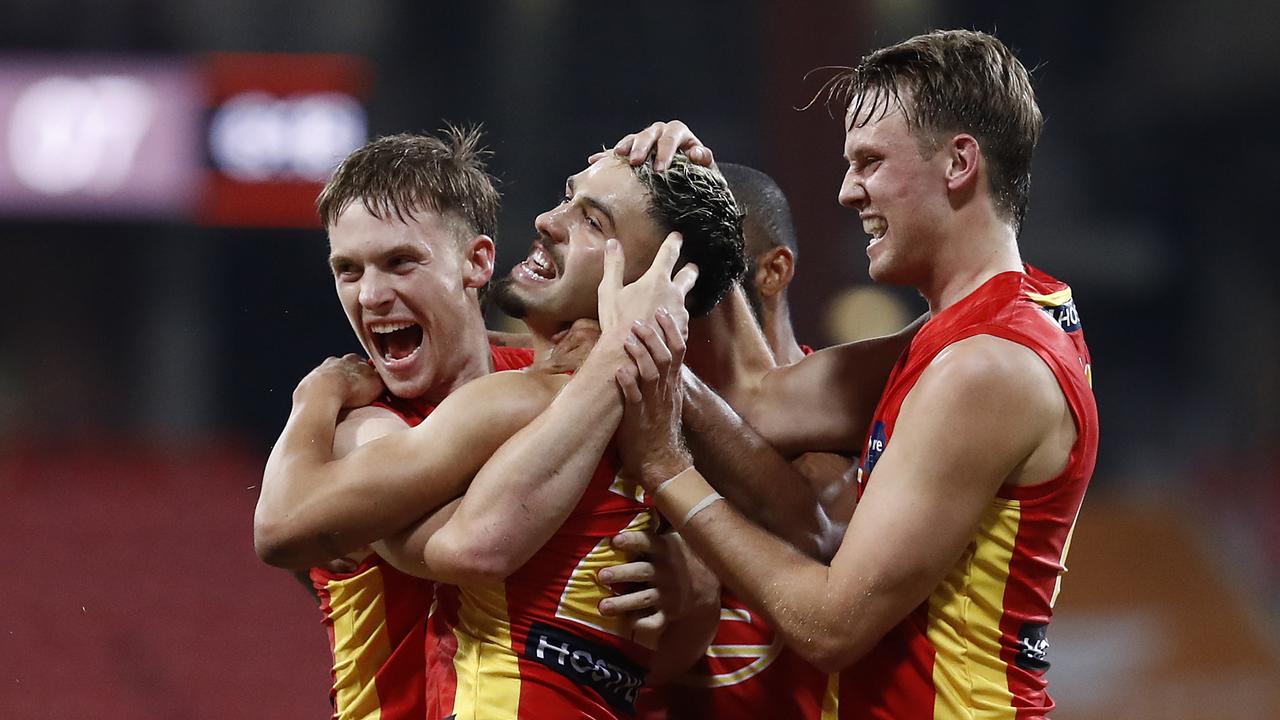 Izak Rankine (middle) was a popular teammate at the Suns. Picture: Getty Images