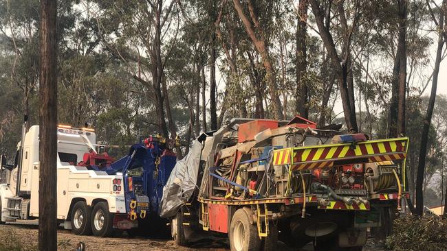 The fire truck in which the two young volunteers were driving when it rolled is towed away. Picture: Twitter