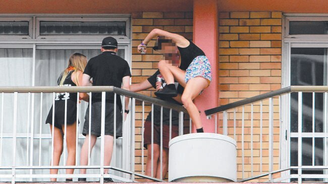 Schoolies acting like foolies by climbing from one balcony to another on the Gold Coast. Picture: Marc Robertson