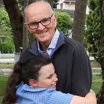 Robert Stark, NSW Grandfather of the Year, gets a hug from granddaughter Ruby, 9. Picture: Supplied