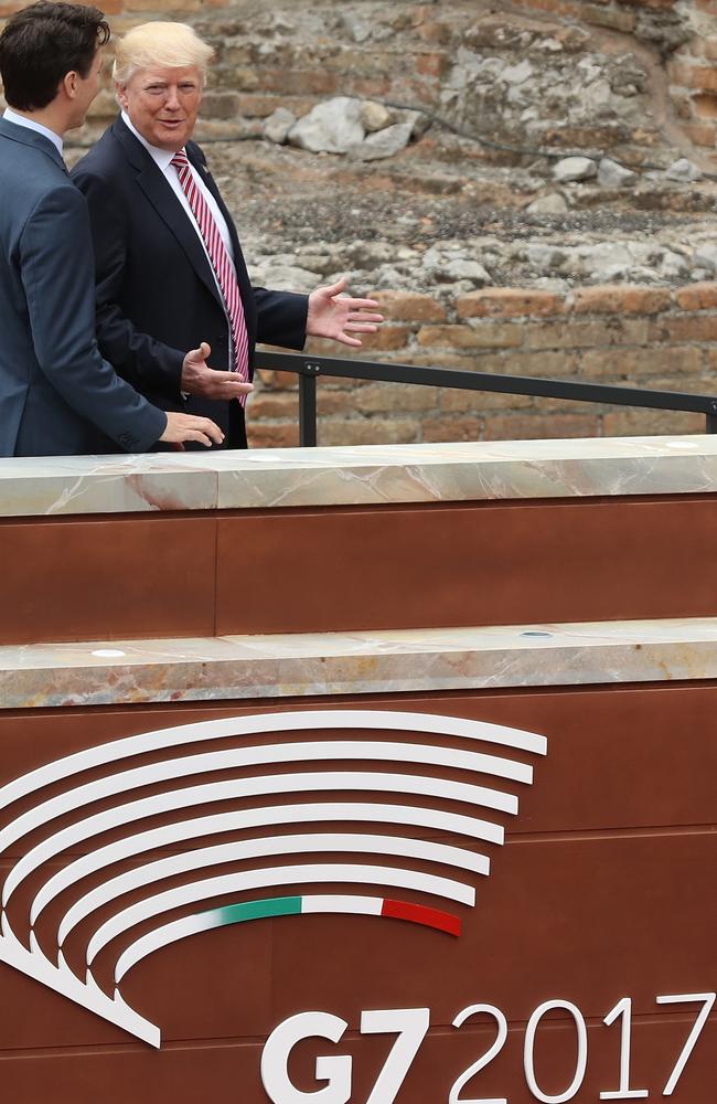 Canadian Prime Minister Justin Trudeau, left, and US President Donald Trump depart after posing for the group photo at the G7 Taormina summit. Picture: Getty.