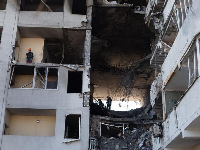 Rescue workers remove rubble from a residential building which was hit by a rocket killing eight including a baby. Picture: Anastasia Vlasova/Getty Images