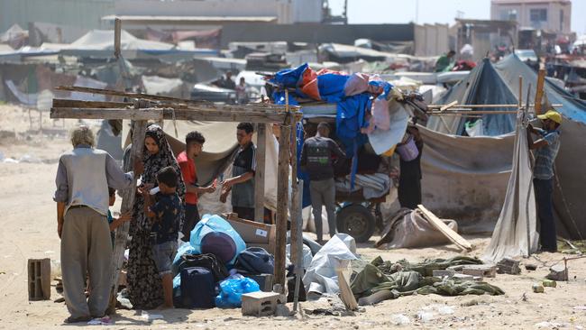 Palestinians dismantle their tent as they prepare to flee a makeshift camp for displaced people in Khan Yunis, in the southern Gaza Strip on Sunday. Picture: AFP