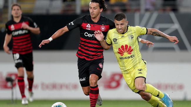 Daniel Georgievski of the Wanderers (left) and Jaushua Sotirio of the Phoenix challenge for the ball. Picture: AAP