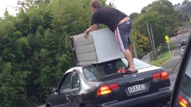 A New Zealand man balances a fridge on top of a car. Source: Facebook, NewLynnCommunity.