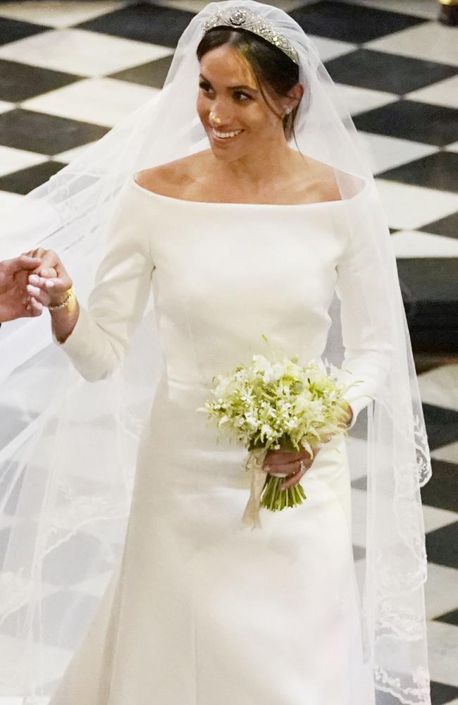 The Duchess of Sussex holds Prince Harry’s hand as she departs following the ceremony. Picture: Jonathan Brady/Getty Images