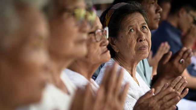 Local women attend a Buddhist prayer for the trapped boys at a school near the Tham Luang cave.