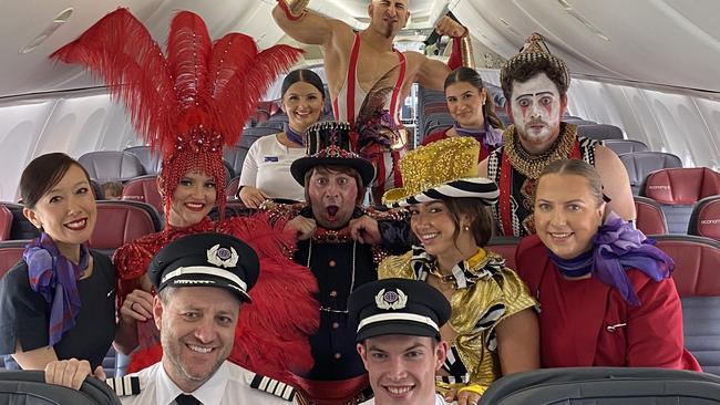 Adelaide Fringe act Pink Flamingo pictured with the Virgin cabin crew. Picture: Supplied