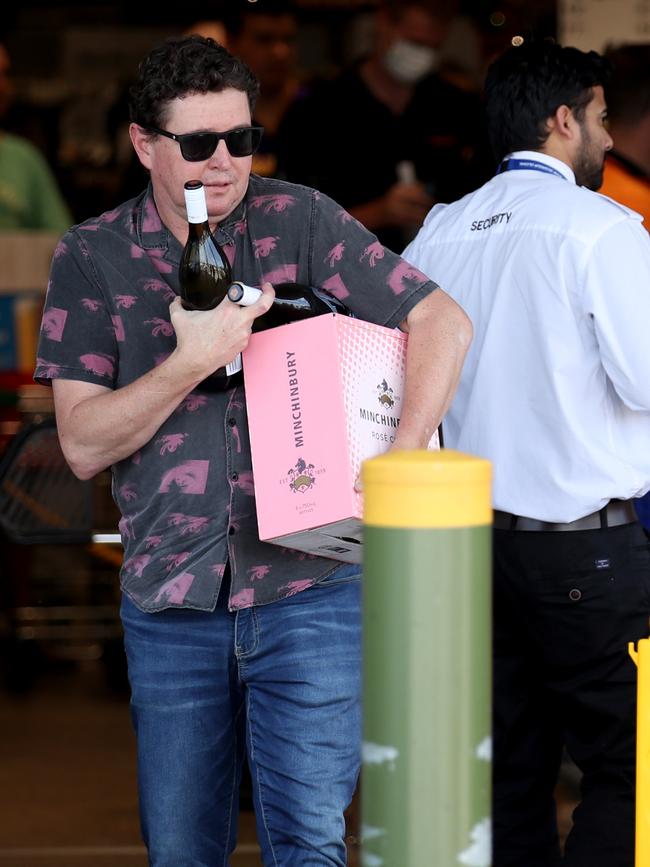 Customers leave Dan Murphy’s in West Torrens after stocking up ahead of lockdown. Picture: Kelly Barnes/Getty Images