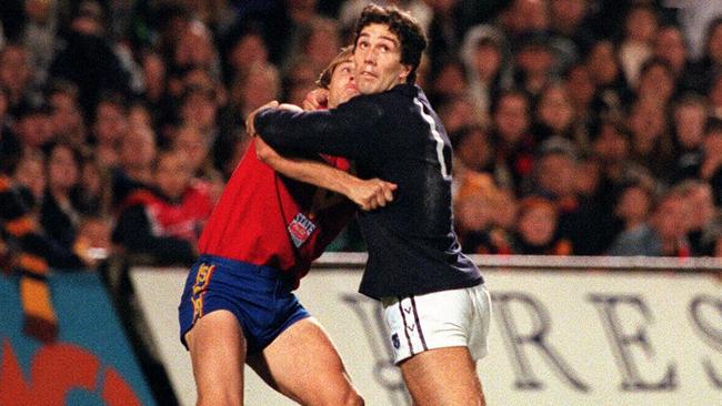 Tony Modra (left) and Stephen Silvagni wrestle for position during a 1997 State of Origin match at Football Park, Adelaide.