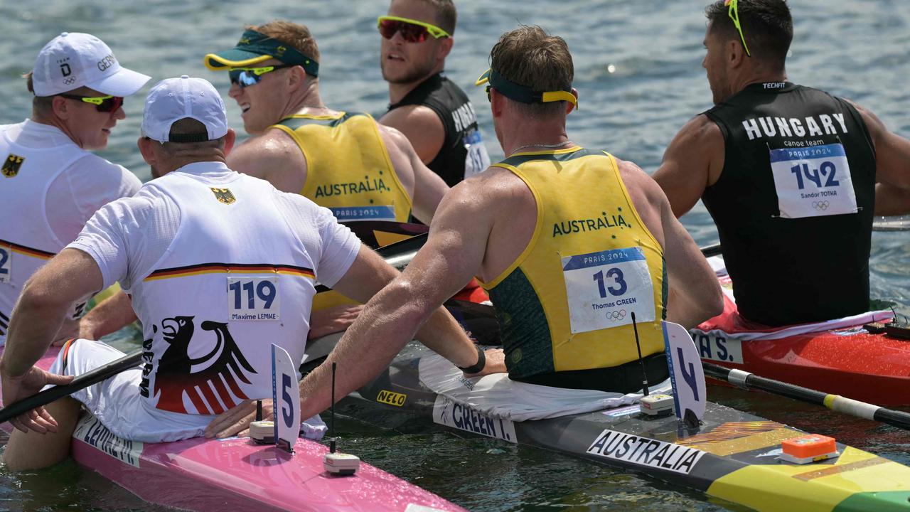 Australia's Jean Van Der Westhuyzen and Thomas Green (middle) wait with crews from Germany and Hungary for the photo finish results. Photo: AFP