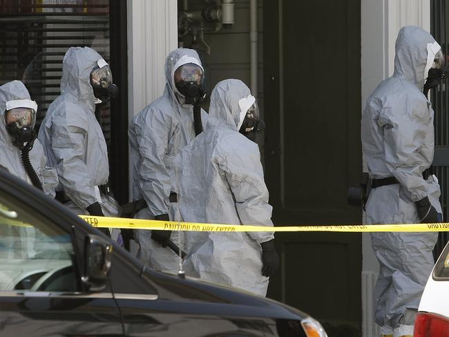 FBI agents in hazardous material suits search a building in San Francisco. AP Photo/San Francisco Chronicle, Michael Short.