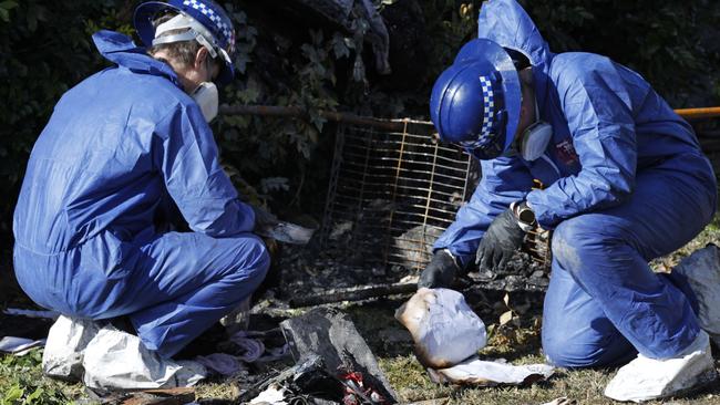 Forensic specialists continued the agonising task of sifting through the charred remains of what appeared to once be a seemingly normal and loving family home. Picture: Richard Dobson