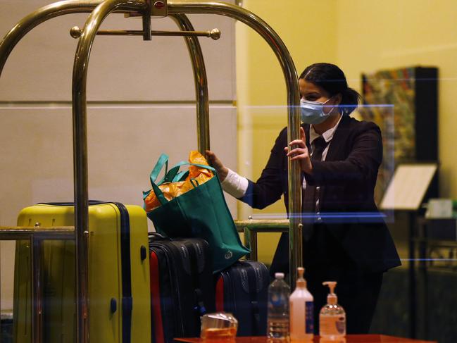 MELBOURNE, AUSTRALIA - JUNE 25: Staff inside the Stamford Hotel in Melbourne are seen moving luggage for  guests in quarantine on June 25, 2020 in Melbourne, Australia. Victorian Premier Daniel Andrews has requested support from the Australian Defence Force to help enforce hotel quarantine following a jump in confirmed COVID-19 cases in the state. Victoria has recorded another 33 cases of COVID-19 overnight, marking the state's ninth consecutive day of double-digit rises. It is the biggest increase in new cases in Victoria in more than two months. Australia also recorded its first COVID-19 death in more than a month yesterday after a Victorian man in his 80s died in hospital, bringing the country's death toll to 103. (Photo by Darrian Traynor/Getty Images)