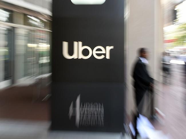 (FILES) In this file pan zoom image, an Uber logo is seen outside the company's headquarters in San Francisco, California on May 8, 2019. - Drivers for ride-share and meal delivery apps filed a lawsuit January 13 to nullify a referendum passed by California voters that lets such "gig workers" be treated as contractors. Labor legislation known as Proposition 22 -- passed in November and heavily backed by backed by Uber, Lyft and other app-based, on-demand delivery services -- effectively overturned a state law requiring them to reclassify their drivers and provide employee benefits. (Photo by Josh Edelson / AFP)