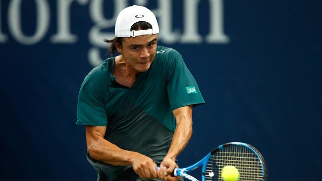 Taro Daniel of Japan returns the ball during his men's singles first round match against Alex de Minaur. Picture: Julian Finney/Getty/AFP