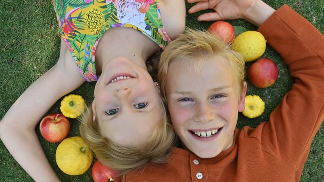 Ellie, 6, and Drew, 9, in their backyard with fruit and veg they grew themselves. Picture: Keryn Stevens