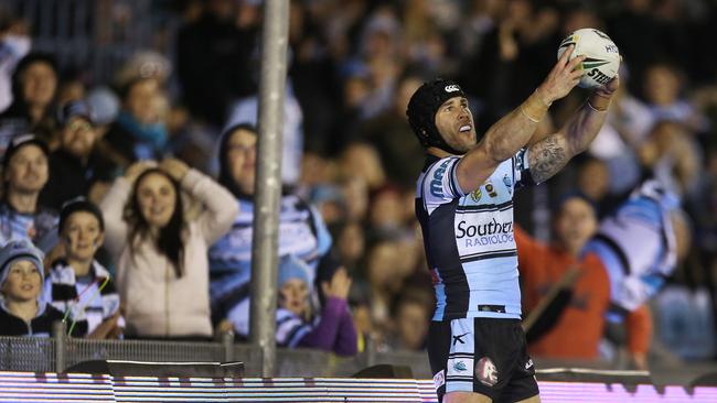 Michael Ennis takes a “selfie” with the ball after scoring a try for the Sharks. Picture: AAP