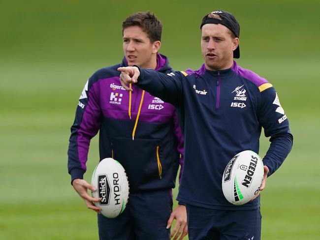 (L-R) Cooper Johns gets some tips from Cameron Munster during a Storm training session. Picture: AAP Image/Scott Barbour