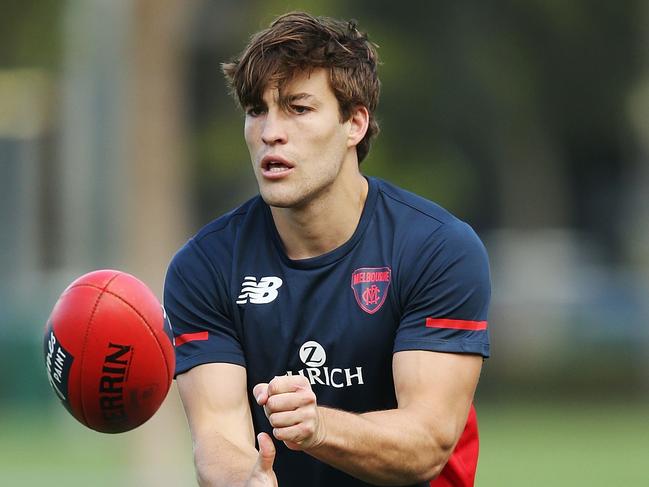 MELBOURNE, AUSTRALIA - FEBRUARY 14:  Jack Viney, coming back from a serious leg injury, handballs during a Melbourne Demons AFL training session at Gosch's Paddock on February 14, 2018 in Melbourne, Australia.  (Photo by Michael Dodge/Getty Images)