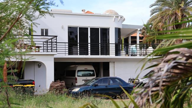 Heavily-armed police officers swarmed on a Cullen Bay Crescent home where they arrested a 53-year-old man over alleged serious harm offences. Picture: Riley Walter