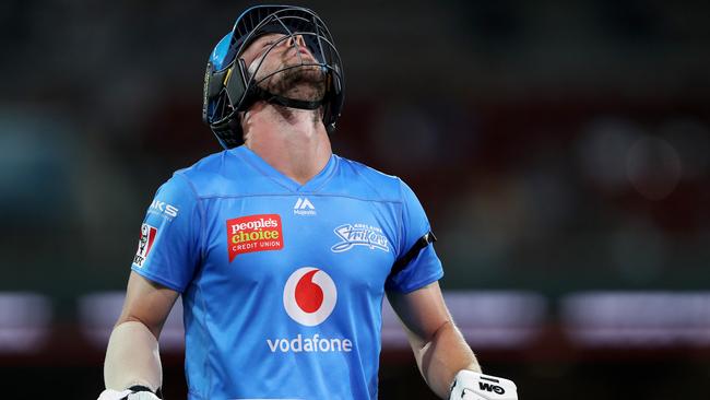 Travis Head reacts after losing his wicket during the Big Bash League match between the Adelaide Strikers and the Hobart Hurricanes at the Adelaide Oval.