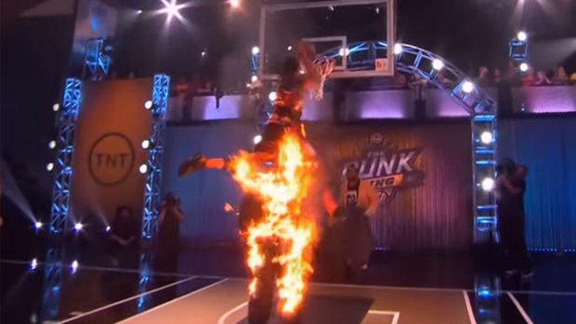 Kenny Dobbs leaps over a human torch to dunk the ball on ‘Dunk King’.