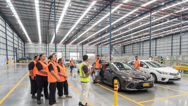 Guy Sebastian and members of the Mount Druitt Choir sing to delivery partners at Amazon's delivery station at Eastern Creek in western Sydney.