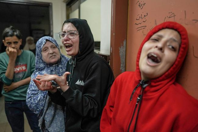 Relatives of the wounded react after an Israeli strike hit central Gaza, doctors at Al-Aqsa Hospital in the Gaza city of Deir al-Balah said